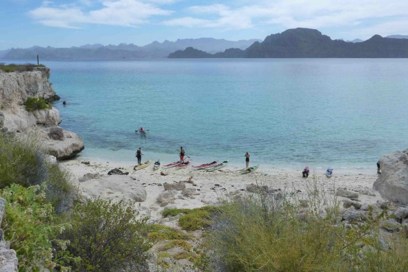 looking out over a white sand beach to Danzante Island and the mountains
