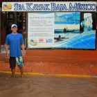 Ramon stands ankle deep in rain outside the Sea Kayak Baja Mexico retail store in Loreto, BCS